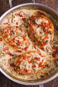 Smothered Pork Chops with Bacon, Mushrooms, and Fresh Thyme Cream Sauce Recipe